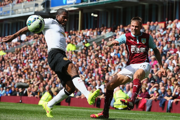BURNLEY, ENGLAND - AUGUST 30:  Luis Antonio Valencia of Manchester United and Matthew Taylor of Burnley battle for the ball during the Barclays Premier League match between Burnley and Manchester United at Turf Moor on August 30, 2014 in Burnley, England.  (Photo by Clive Brunskill/Getty Images)