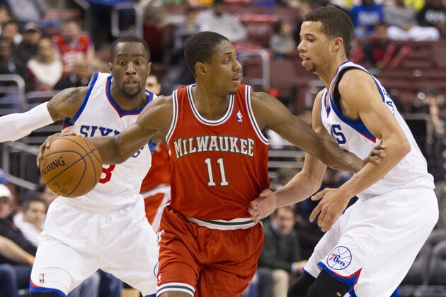 Milwaukee Bucks' Brandon Knight, center, in action against Philadelphia 76ers' Michael Carter-Williams, right, as Tony Wroten, eyes the ball during the second half of an NBA basketball game, Monday, Feb. 24, 2014, in Philadelphia. The Bucks won 130-110. (AP Photo/Chris Szagola)