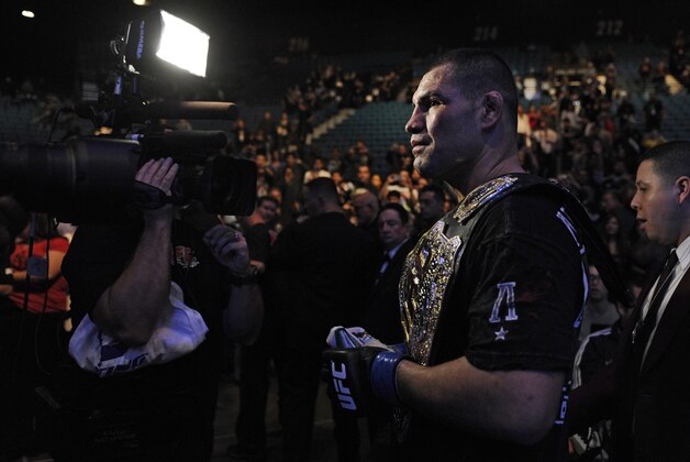 Cain Velasquez exits the octagon after defeating Junior dos Santos of Brazil in a UFC 155 heavyweight championship mixed martial arts match at the MGM Grand Garden Arena Saturday, Dec. 29, 2012 in Las Vegas. Velasquez reclaimed the title with a unanimous decision. (AP Photo/David Becker)
