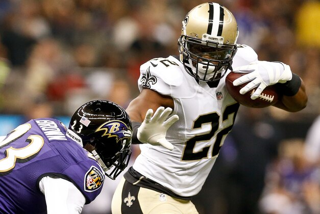 Aug 28, 2014; New Orleans, LA, USA; New Orleans Saints running back Mark Ingram (22) stiff arms Baltimore Ravens defensive back Chykie Brown (23) during the first quarter of a preseason game at Mercedes-Benz Superdome. Mandatory Credit: Derick E. Hingle-USA TODAY Sports