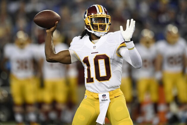Washington Redskins quarterback Robert Griffin III throws to a receiver in the first half of an NFL preseason football game against the Baltimore Ravens, Saturday, Aug. 23, 2014, in Baltimore. (AP Photo/Nick Wass)