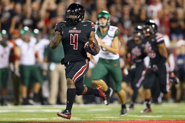 LOUISVILLE, KY - SEPTEMBER 01:  Crovin Lamb #4 of the Louisville Cardinals runs for a touchdown on a kick off return during the game against the Miami Huricanesat Papa John's Cardinal Stadium on September 1, 2014 in Louisville, Kentucky.  (Photo by Andy Lyons/Getty Images)