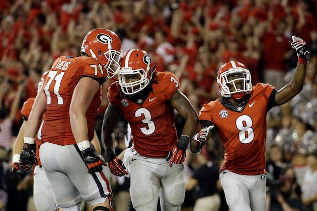 Georgia running back Todd Gurley (3) celebrates with teammates after scoring in the second half of an NCAA college football game against Clemson, Saturday, Aug. 30, 2014, in Athens, Ga. (AP Photo/David Goldman)