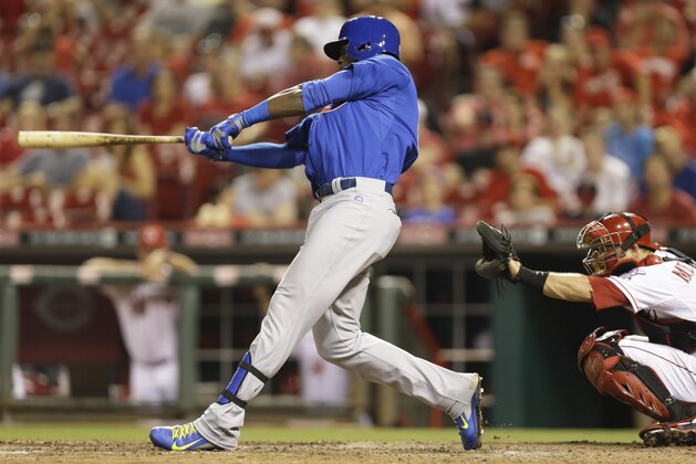 Chicago Cubs' Jorge Soler gets a hit off Cincinnati Reds relief pitcher Jonathan Broxton to drive in a run in the eighth inning of a baseball game, Wednesday, Aug. 27, 2014, in Cincinnati. Soler was making his major league debut. Cincinnati won 7-5. Devin Mesoraco catches at right. (AP Photo/Al Behrman)