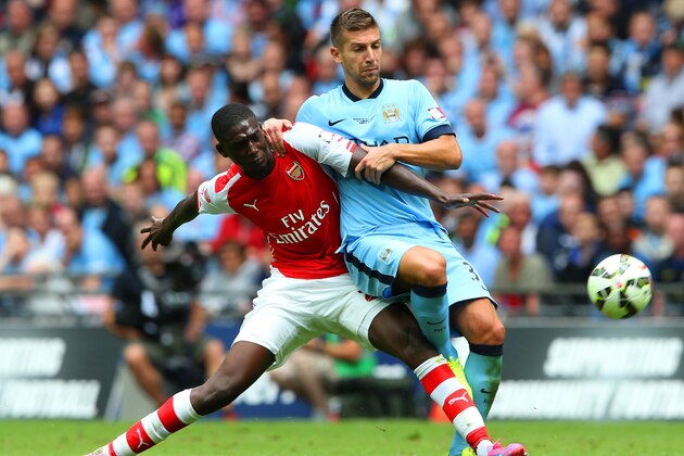 LONDON, ENGLAND - AUGUST 10: Yaya Sanogo of Arsenal challenges Matija Nastasic of Manchester City during the FA Community Shield match between Manchester City and Arsenal at Wembley Stadium on August 10, 2014 in London, England.  (Photo by David Rogers/Getty Images)
