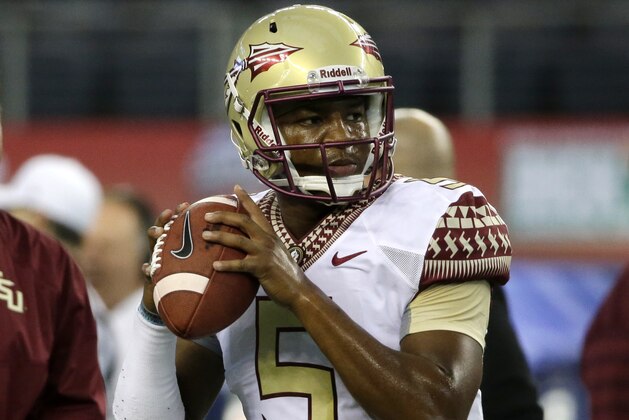 Florida State quarterback Jameis Winston (5) throws a pass during warm ups before an NCAA college football game against Oklahoma State, Saturday, Aug. 30, 2014, in Arlington, Texas. (AP Photo/Tony Gutierrez)