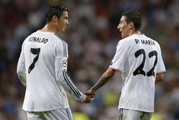 Real's Angel Di Maria, right is congratulated by Real's Cristiano Ronaldo after he scored during the Champions League group B soccer match between Real Madrid and FC Copenhagen at the Santiago Bernabeu stadium in Madrid, Wednesday, Oct. 2, 2013. (AP Photo/Daniel Ochoa de Olza)