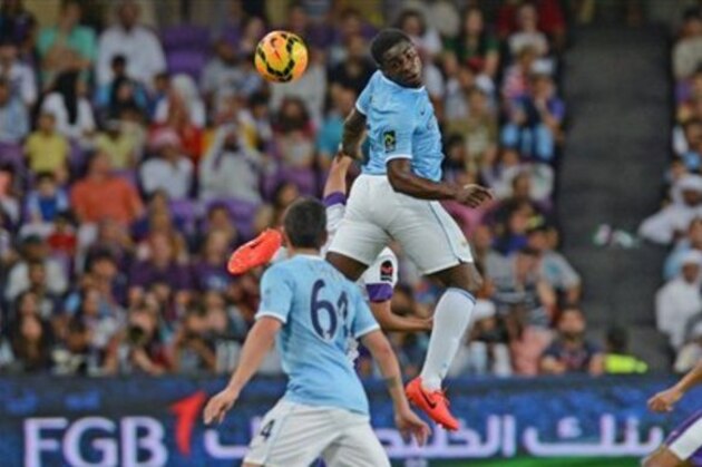 Manchester City's Micah Richards,  centre, heads the ball during the soccer friendly match between Manchester City and  United Arab Emirates team, Al Ain, in Al Ain, United Arab Emirates, Thursday, May 15, 2014. (AP Photo)