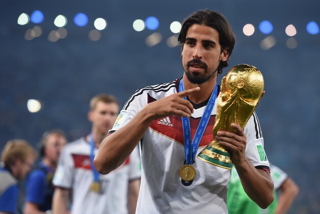 RIO DE JANEIRO, BRAZIL - JULY 13:  Sami Khedira of Germany celebrates with the World Cup trophy  after defeating Argentina 1-0 in extra time during the 2014 FIFA World Cup Brazil Final match between Germany and Argentina at Maracana on July 13, 2014 in Rio de Janeiro, Brazil.  (Photo by Matthias Hangst/Getty Images)