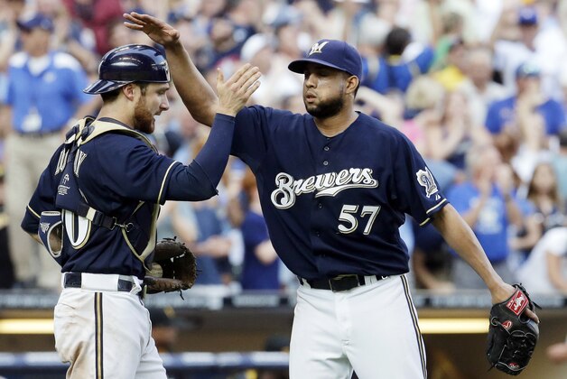 Milwaukee Brewers catcher Jonathan Lucroy and Francisco Rodriguez (57) celebrate their 4-3 over the Pittsburgh Pirates after a baseball game Sunday, Aug. 24, 2014, in Milwaukee. (AP Photo/Morry Gash)