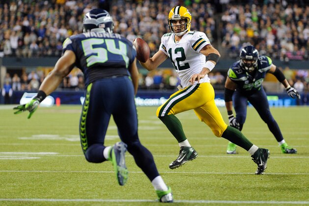 Sep 24, 2012; Seattle, WA, USA; Green Bay Packers quarterback Aaron Rodgers (12) looks for an open receiver while running from Seattle Seahawks middle linebacker Bobby Wagner (54) during the 2nd half at CenturyLink Field. Seattle defeated Green Bay 14-12. Mandatory Credit: Steven Bisig-USA TODAY Sports