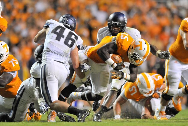 Aug 31, 2014; Knoxville, TN, USA; Tennessee Volunteers running back Marlin Lane (15) rushes against Utah State Aggies safety Frankie Sutera (46) during the second half at Neyland Stadium. Tennessee won 38-7. Mandatory Credit: Jim Brown-USA TODAY Sports