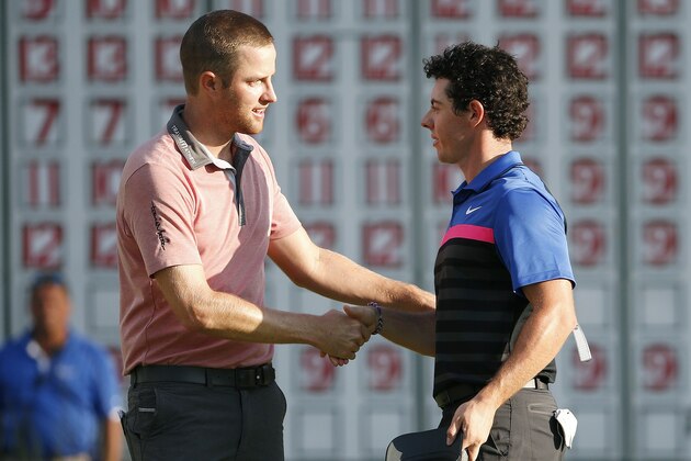 Chris Kirk, left, shakes hands with Rory McIlroy after finishing on the 18th hole of the  Deutsche Bank Championship golf tournament in Norton, Mass., Monday, Sept. 1, 2014. Kirk won with 15-under par. (AP Photo/Michael Dwyer)