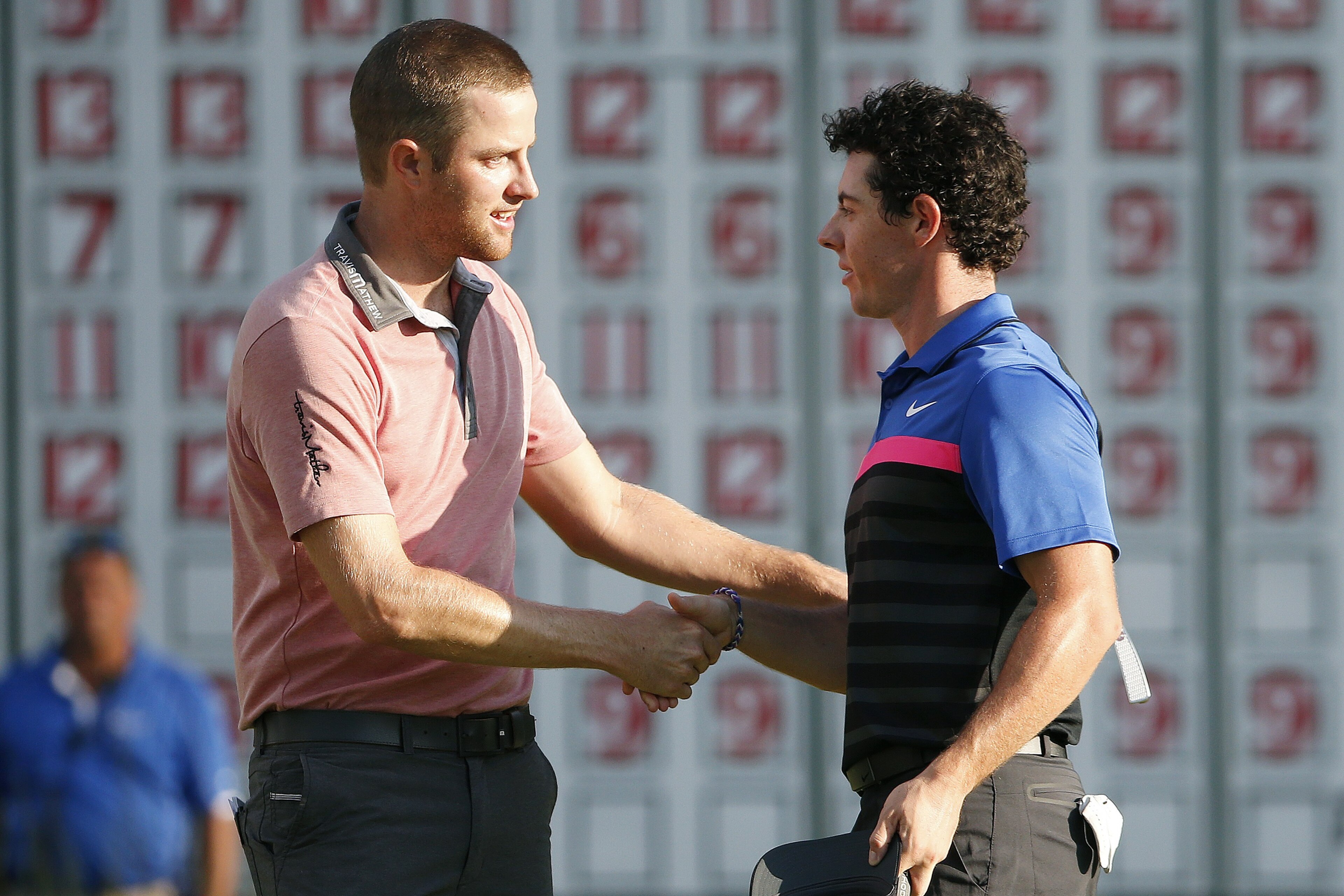 Chris Kirk, left, shakes hands with Rory McIlroy after finishing on the 18th hole of the  Deutsche Bank Championship golf tournament in Norton, Mass., Monday, Sept. 1, 2014. Kirk won with 15-under par. (AP Photo/Michael Dwyer)