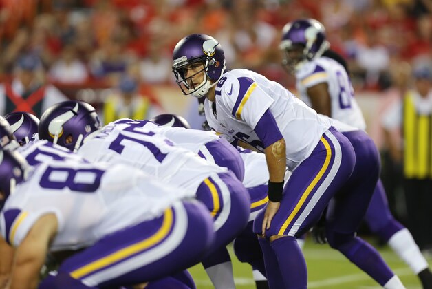 Minnesota Vikings quarterback Matt Cassel, right, calls a play at the line of scrimmage during the first half of an NFL preseason football game against the Kansas City Chiefs in Kansas City, Mo., Saturday, Aug. 23, 2014. (AP Photo/Ed Zurga)