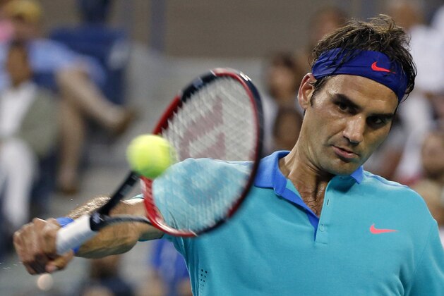 Roger Federer, of Switzerland, returns the ball against Marcel Granollers, of Spain, during the third round of the U.S. Open tennis tournament, Sunday, Aug. 31, 2014, in New York. (AP Photo/Elise Amendola)