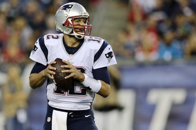 New England Patriots quarterback Tom Brady looks for a receiver against the Carolina Panthers defense in the first half of an NFL preseason football game Friday, Aug. 22, 2014, in Foxborough, Mass. (AP Photo/Charles Krupa)