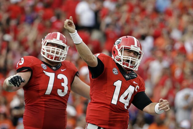 Georgia quarterback Hutson Mason, right,  celebrates after running the ball to score a touchdown in the first half of an NCAA college football game against Clemson, Saturday, Aug. 30, 2014, in Athens, Ga. (AP Photo/David Goldman)