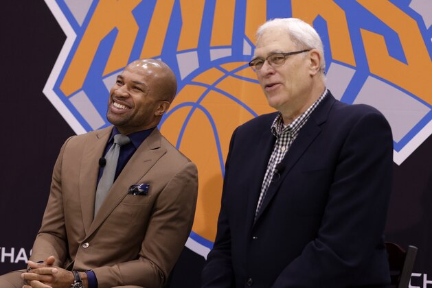 Derek Fisher, left, laughs, while New York Knicks president Phil Jackson speaks during a news conference in Tarrytown, N.Y., Tuesday, June 10, 2014. The Knicks hired Fisher as their new coach on Tuesday, with Jackson turning to one of his trustiest former players. (AP Photo/Seth Wenig)