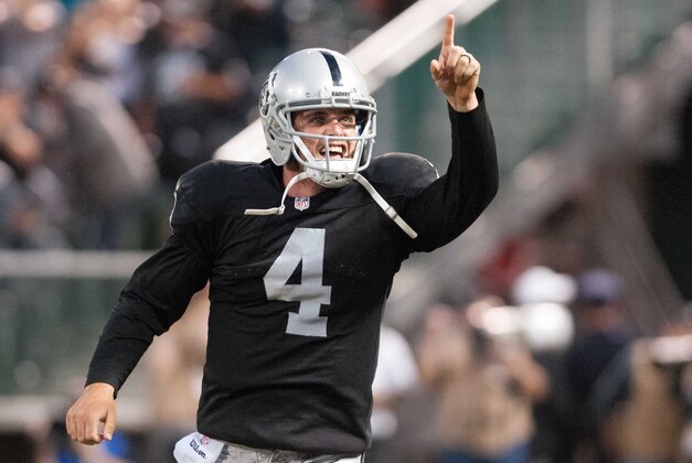 Aug 28, 2014; Oakland, CA, USA; Oakland Raiders quarterback Derek Carr (4) celebrates after throwing a touchdown pass against the Seattle Seahawks during the second quarter at O.co Coliseum. Mandatory Credit: Ed Szczepanski-USA TODAY Sports