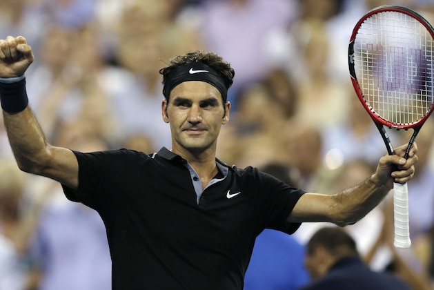 Roger Federer, of Switzerland, raises his arms after defeating Roberto Bautista Agut, of Spain, 6-4, 6-3, 6-2 during the fourth round of the U.S. Open tennis tournament, Tuesday, Sept. 2, 2014, in New York. (AP Photo/Charles Krupa)