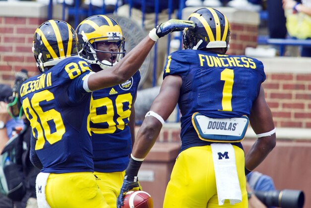Michigan wide receiver Devin Funchess (1) celebrates his touchdown with quarterback Devin Gardner (98) and wide receiver Jehu Chesson (86), in the first quarter of an NCAA college football game against Appalachian State in Ann Arbor, Mich., Saturday, Aug. 30, 2014. (AP Photo/Tony Ding) Michigan wide receiver Devin Funchess (1) celebrates his touchdown with quarterback Devin Gardner (98) and wide receiver Jehu Chesson (86), in the first quarter of an NCAA college football game against Appalachian State in Ann Arbor, Mich., Saturday, Aug. 30, 2014. (AP Photo/Tony Ding)