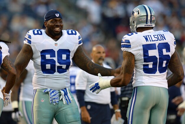 Aug 7, 2014; San Diego, CA, USA; Dallas Cowboys defensive tackle Henry Melton (69) congratulates defensive end Martez Wilson (56) after the Cowboys recovered a fumble during the first quarter against the San Diego Chargers at Qualcomm Stadium. Mandatory Credit: Jake Roth-USA TODAY Sports