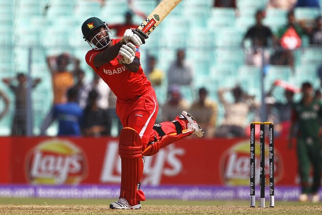 KOLKATA, INDIA - MARCH 20:  Prosper Utseya of Zimbabwe hits a six during the ICC World Cup match between Kenya and Zimbabwe at Eden Gardens on March 20, 2011 in Kolkata, India.  (Photo by Matthew Lewis/Getty Images)