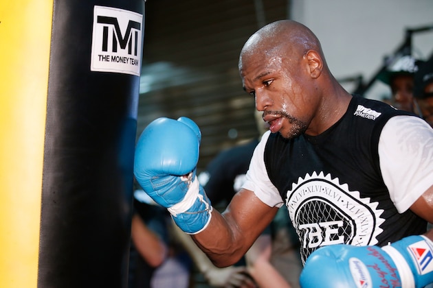 LAS VEGAS, NV - SEPTEMBER 02:  Boxer Floyd Mayweather Jr. (L) works out at the Mayweather Boxing Club on September 2, 2014 in Las Vegas, Nevada. Mayweather Jr. will defend his WBC/WBA welterweight titles against Marcos Maidana on September 13 in Las Vegas.  (Photo by Eric Jamison/Getty Images)