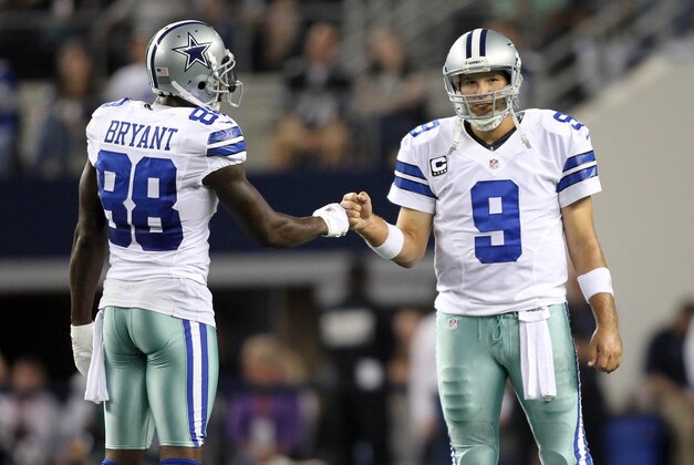 Dec 2, 2012; Arlington, TX, USA; Dallas Cowboys wide receiver Dez Bryant (88) bumps fists with quarterback Tony Romo (9) during the game against the Philadelphia Eagles at Cowboys Stadium. Mandatory Credit: Tim Heitman-USA TODAY Sports