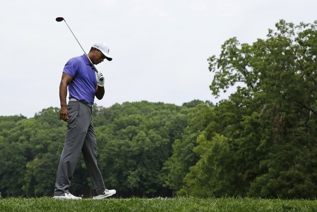 Tiger Woods react to a poor tee shot on the second hole during the first round of the PGA Championship golf tournament at Valhalla Golf Club on Thursday, Aug. 7, 2014, in Louisville, Ky. (AP Photo/John Locher)