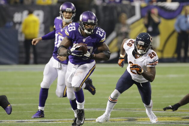 Minnesota Vikings running back Adrian Peterson (28) runs from Chicago Bears cornerback Tim Jennings (26) during overtime of an NFL football game, Sunday, Dec. 1, 2013, in Minneapolis.  The Vikings won 23-20. (AP Photo/Ann Heisenfelt)