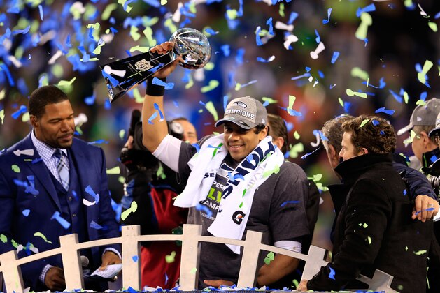 EAST RUTHERFORD, NJ - FEBRUARY 02:  Russell Wilson #3 of the Seattle Seahawks celebrates with the Vince Lombardi trophy after defeating the Denver Broncos 43-8 in Super Bowl XLVIII at MetLife Stadium on February 2, 2014 in East Rutherford, New Jersey.  (Photo by Rob Carr/Getty Images)