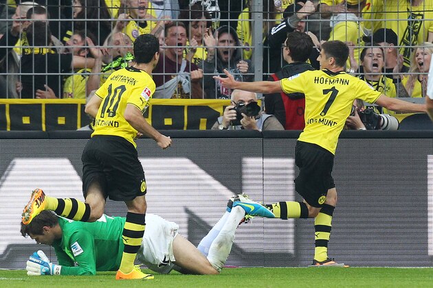 Dortmund's Jonas Hofmann, right, celebrates the opening goal for his side during a German soccer Bundesliga match between Borussia Dortmund and Eintracht Braunschweig in Dortmund, Germany, Sunday, Aug. 18, 2013. (AP Photo/Michael Probst)