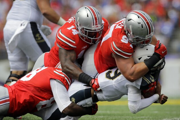 Ohio State defensive lineman Steve Miller, from left, linebacker Curtis Grant and defensive lineman Joey Bosa sack Navy quarterback Keenan Reynolds in the first half of an NCAA college football game in Baltimore, Saturday, Aug. 30, 2014. (AP Photo/Patrick Semansky) Ohio State defensive lineman Steve Miller, from left, linebacker Curtis Grant and defensive lineman Joey Bosa sack Navy quarterback Keenan Reynolds in the first half of an NCAA college football game in Baltimore, Saturday, Aug. 30, 2014. (AP Photo/Patrick Semansky)