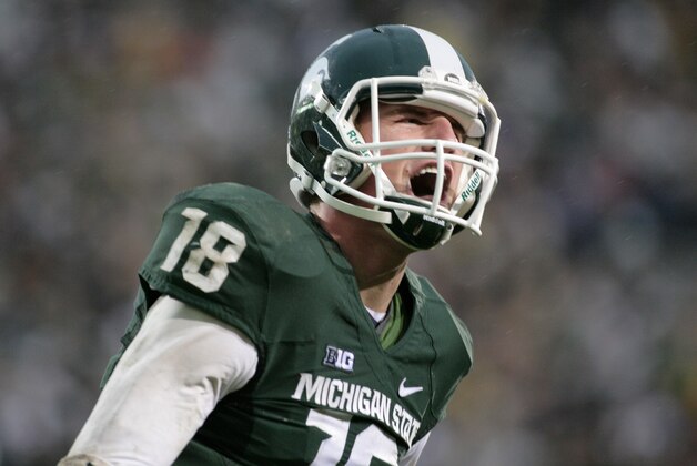FILE - In this Nov. 2, 2013, file photo,  Michigan State quarterback Connor Cook yells in celebration after scoring a touchdown against Michigan during an NCAA college football game, in East Lansing, Mich. Cook finished the 2013 season strong, throwing for 304 yards and three touchdowns against Ohio State in the Big Ten championship game and for a career-high 332 yards and two TDs against Stanford while being named Offensive MVP of the Rose Bowl. (AP Photo/Al Goldis)