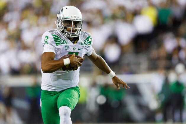 Oregon quarterback Marcus Mariota (8) runs with the football during the second quarter of an NCAA college football game in Eugene, Ore., Saturday, Aug. 30, 2014 (AP Photo/Ryan Kang)