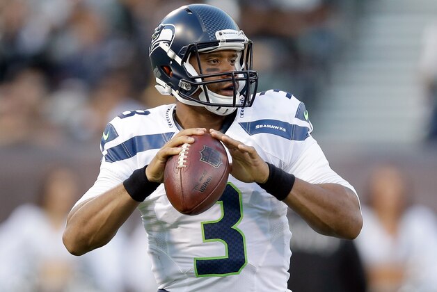 OAKLAND, CA - AUGUST 28:  Quarterback Russell Wilson #3 of the Seattle Seahawks in action against the Oakland Raiders at O.co Coliseum on August 28, 2014 in Oakland, California.  (Photo by Ezra Shaw/Getty Images)