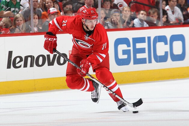 RALEIGH, NC - OCTOBER 06: Drayson Bowman #21 of the Carolina Hurricanes carries the puck during an NHL game against the Philadelphia Flyers on October 6, 2013 at PNC Arena in Raleigh, North Carolina.  (Photo by Gregg Forwerck/NHLI via Getty Images)