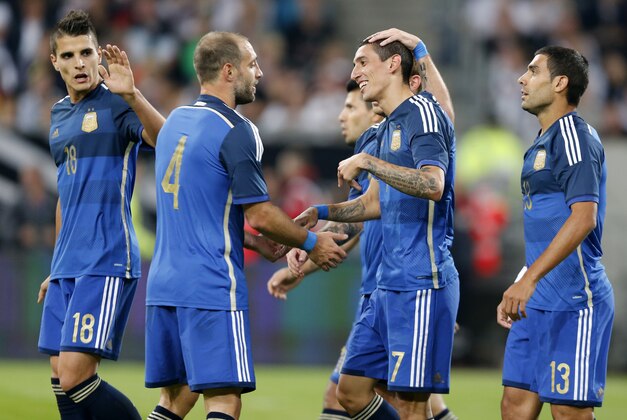 Argentina's players celebrate their side's fourth goal by Angel Di Maria, 2nd right, during the friendly soccer match between Germany and Argentina in Duesseldorf, Germany, Wednesday, Sept. 3, 2014. (AP Photo/Frank Augstein)