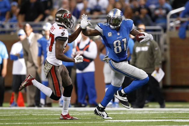 Detroit Lions wide receiver Calvin Johnson (81) runs for yardage after a catch against the Tampa Bay Buccaneers during the fourth quarter of an NFL football game at Ford Field in Detroit, Sunday, Nov. 24, 2013. (AP Photo/Paul Sancya)