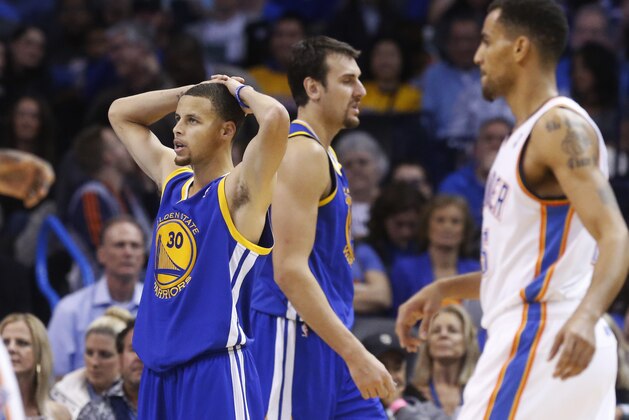 Golden State Warriors guard Stephen Curry (30) puts his hands on his head in reaction to a whistle in the third quarter of an NBA basketball game against the Oklahoma City Thunder in Oklahoma City, Friday, Nov. 29, 2013. Oklahoma City won 113-112. Teammate Andrew Bogut and Oklahoma City Thunder guard Thabo Sefolosha (25) are at right. (AP Photo/Sue Ogrocki)