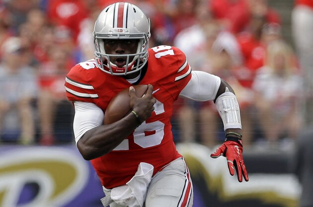 Ohio State quarterback J.T. Barrett rushes the ball in the second half of an NCAA college football game against Navy in Baltimore, Saturday, Aug. 30, 2014. (AP Photo/Patrick Semansky)