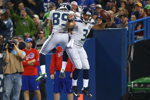 TORONTO, ON - DECEMBER 16: Russell Wilson #3 of the Seattle Seahawks celebrates his rushing touchdown with Doug Baldwin #89 during an NFL game against the Buffalo Bills at Rogers Centre on December 16, 2012 in Toronto, Ontario, Canada. (Photo by Tom Szczerbowski/Getty Images)