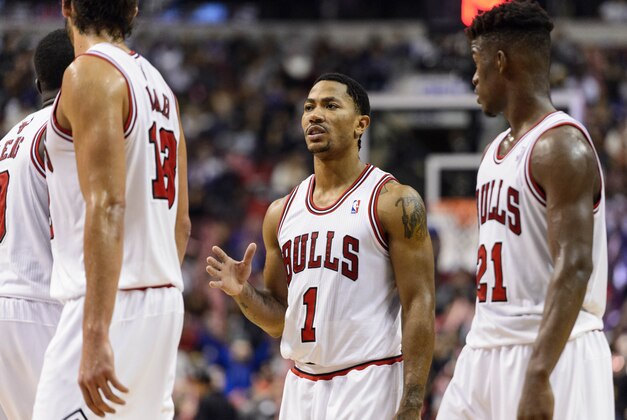 Nov 2, 2013; Philadelphia, PA, USA; Chicago Bulls guard Derrick Rose (1) talks with forward Luol Deng (9) center Joakim Noah (13) and guard Jimmy Butler (21) during the fourth quarter against the Philadelphia 76ers at Wells Fargo Center. The Sixers defeated the Bulls 107-104. Mandatory Credit: Howard Smith-USA TODAY Sports