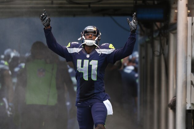 Seattle Seahawks cornerback Byron Maxwell runs out of the tunnel before a preseason NFL football game against the San Diego Chargers, Friday, Aug. 15, 2014, in Seattle. (AP Photo/John Froschauer)