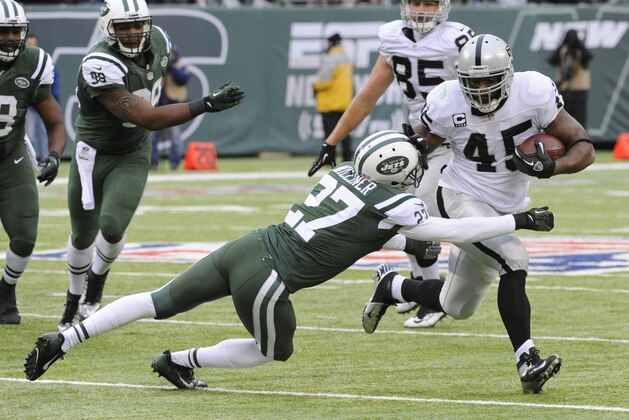 New York Jets cornerback Dee Milliner (27) attempts to tackle Oakland Raiders fullback Marcel Reece during the first half of an NFL football game, Sunday, Dec. 8, 2013, in East Rutherford, N.J. (AP Photo/Bill Kostroun)