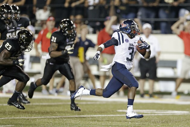 Mississippi running back Jeff Scott (3) scores a touchdown on a 75-yard run with 1:07 left in the fourth quarter to give Mississippi a 39-35 win over Vanderbilt in an NCAA college football game on Friday, Aug. 30, 2013, in Nashville, Tenn. (AP Photo/Mark Humphrey)