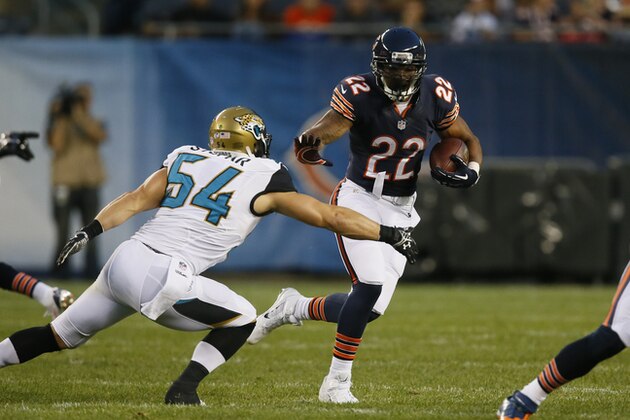 Chicago Bears running back Matt Forte (22) tries to avoid a tackle by Jacksonville Jaguars linebacker Nate Stupar (54) during the first half of an NFL preseason football game in Chicago, Thursday, Aug. 14, 2014. (AP Photo/Andrew Nelles)