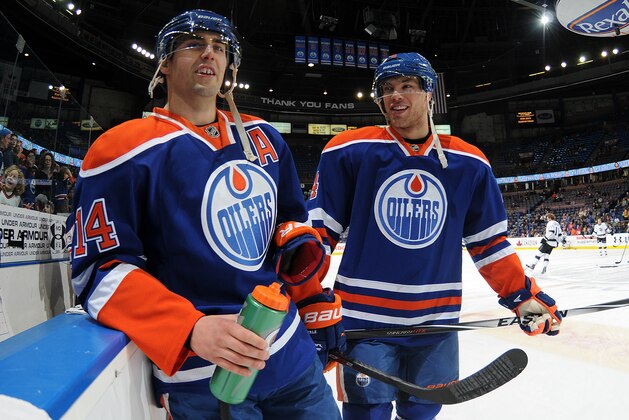 EDMONTON, AB - APRIL 10: Taylor Hall #4 and Jordan Eberle #14 of the Edmonton Oilers converse prior to a game against the Los Angeles Kings on April 10, 2014 at Rexall Place in Edmonton, Alberta, Canada. (Photo by Andy Devlin/NHLI via Getty Images)